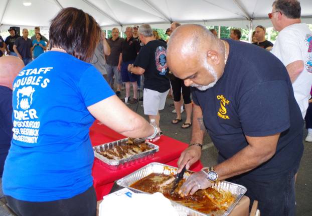Renowned rib master Eric Figueroa of the Double S Diner prepares to bring his ribs to the waiting firefighters.