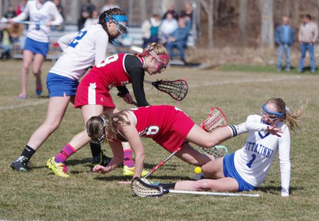 Lacrosse players tumble during play.