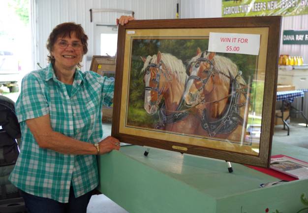 Well-known Sussex County artist Carol Decker stands besides her work entitled &quot;Buck and Babe.&quot; The artwork is being raffled to help with improvements being made to the Richards Building at the fairgrounds. To purchase a ticket call 973-948-5500, extension 221. Raffle tickets will also be available during the fair at the administration building.