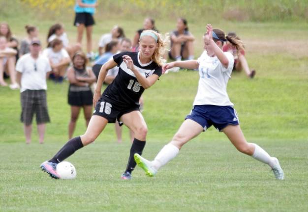 Wallkill Valley Ranger Brittany Todd is challenged by Sparta's Kelly Carolan for control of the ball.