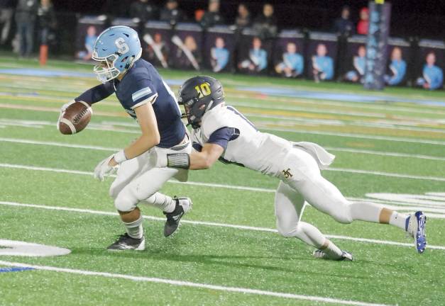 After catching the ball Sparta wide receiver Colby Plotts is grabbed by Jefferson defensive back Caleb Rippey in the second quarter.