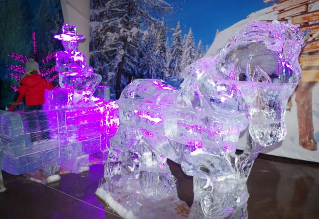 A frozen horse and wagon created from many rectangular blocks of ice.
