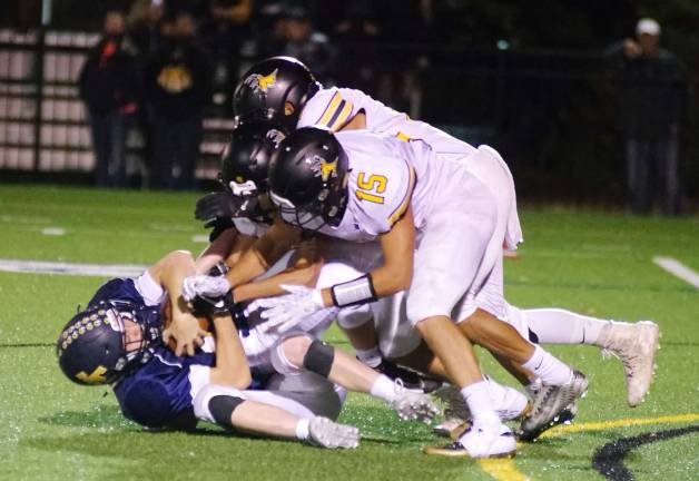 Jefferson ball carrier Paul Monaco is put down by a wall of West Milford defenders in the first quarter.