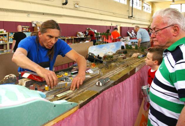 Lafayette artist Bill Frankenfield, also known as &#xfe;&#xc4;&#xfa;Billy the Kid&#xfe;&#xc4;&#xf9; makes some adjustments to the railcars and tracks on his &#xfe;&#xc4;&#xfa;N&#xfe;&#xc4;&#xf9; gauge railroad. The &#xfe;&#xc4;&#xfa;N&#xfe;&#xc4;&#xf9; gauge ratio is 160:1, or in other words, one inch equals a little over 13 feet.