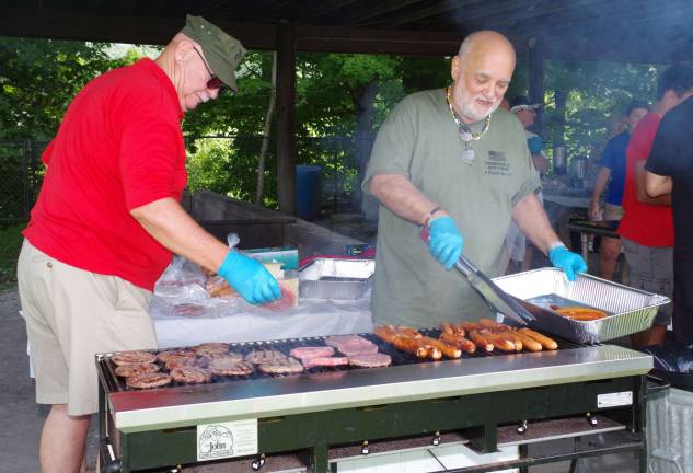 Manning the grill were veterans Charles Hentz and Frank Arminio.