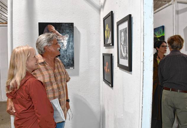 Photos: Meet the Artists Reception at State Fair <b>Judy and Rick Nothstine of Andover look at the art.</b>