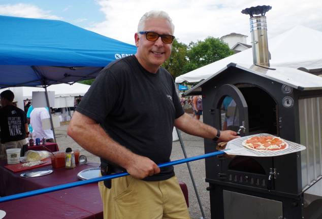 Anthony Riccio, CEO and president of Cava Winery &amp; Vineyard, manned the wood-burning pizza over throughout the hot afternoon.