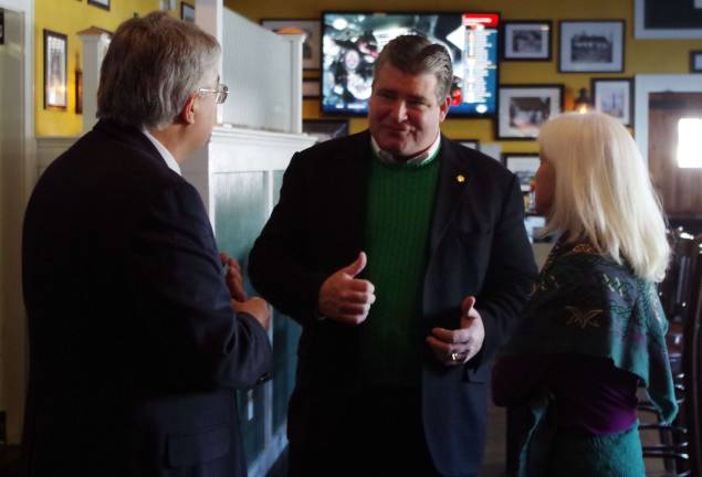 At center, state Sen. Steve Oroho speaks with Grand Marshals Dennis and Mary Harrington in the front room at The Irish Cottage Inn in Franklin on Saturday.