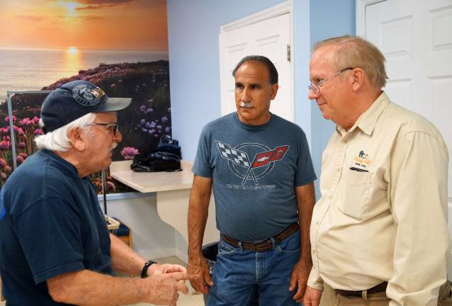 From left, customer Thomas Reilly speaks with owners Tony Pecoraro and Gary Gardner.