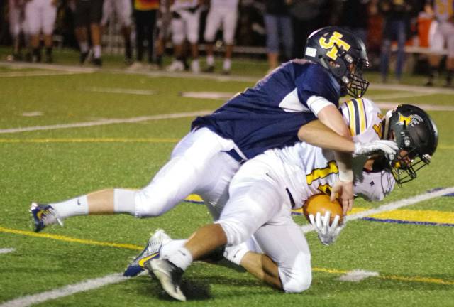 Jefferson defender Matt D'Alessio tackles West Milford ball carrier Dan Diminno during a kick return in the first quarter. D'Alessio made six tackles.