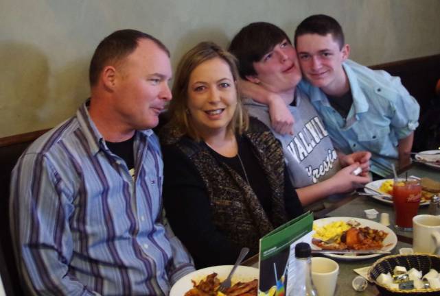 As her sons Grant and Logan fool around, Assemblywoman Alison McHose sits with her husband Morgan at The Irish Cottage Inn.
