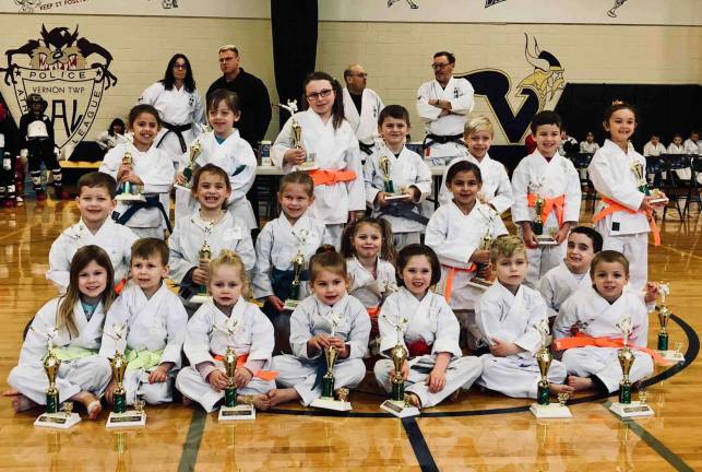 Ranger level students show off the trophies they won for their Kata performances.