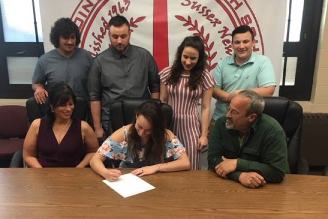 Michaela Thiessen, seated middle, signs to continue her field hockey career at Centenary University. Pictured seated are (left to right): mother Karen O'Krepky, Michaela, and father Ted Thiessen. Standing from left to right are: brothers Jack, Craig, sister Dominique and brother Kendrick.