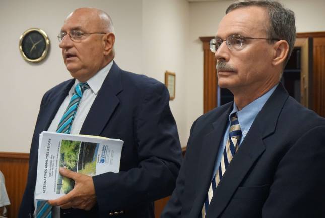 Photos by Vera Olinski Engineers Eugene Buczynski and Petere Olieman clarify the DEP in preparation for the Ogdensburg special meeting schedule don July 27.