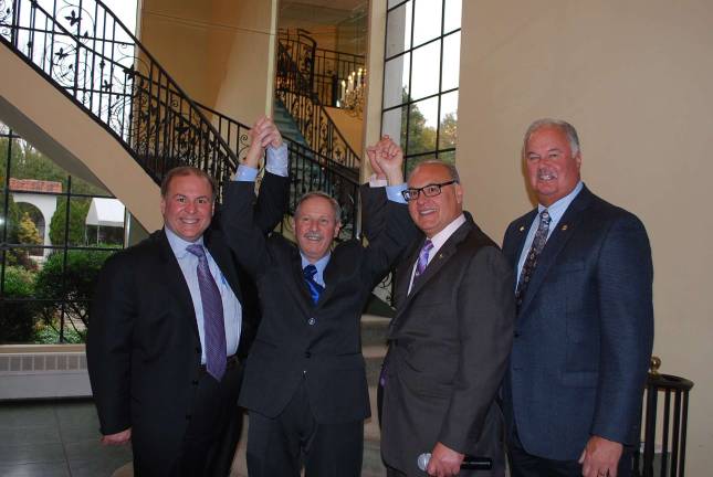 RoNetco Supermarkets honors longtime associates Raymond Costanzo, arms raised is the first 50-year employee at RoNetco Supermarkets. He is shown with, from left, David P. Romano, vice President & C.F.O., Dominick J. Romano, vice president & C.O.O., and Hank Ramberger, general manager.