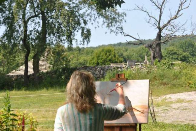 Lisa Hannick who's a professional artist is painting a dead tree seen from the hollow below the main center. It's in stark contrast to the other trees and flowers in full bloom all around &#x2014; although the artist could not say why she had chosen that particular spot.