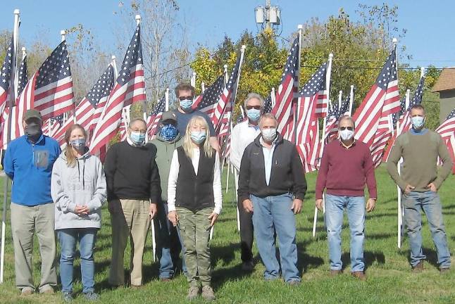 Flags for Heroes fly in Vernon Volunteers complete the task of flag placement and pose for a photo on a crisp autumn Saturday (Photo by Janet Redyke)