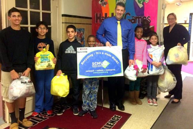 Halstead Middle school students are shown with bags of recycling material.