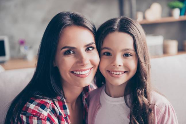 Get mom’s photo in the paper this Mother’s Day Support trust stable strong family concept. Close up portrait of happy tender smiling mom and her lovely cute preteen child they are hugging
