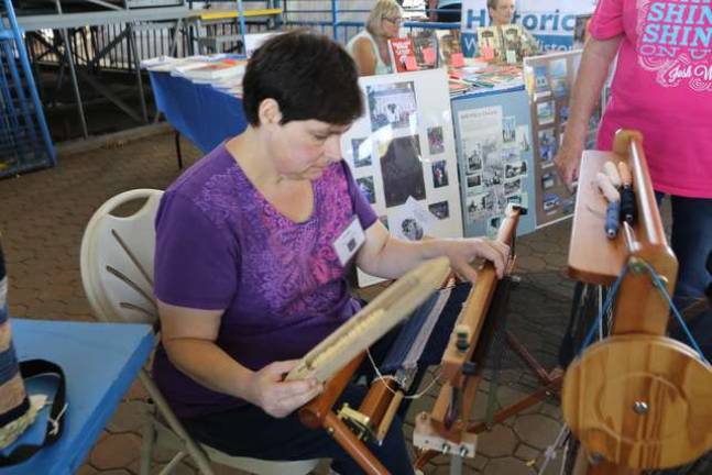 Fawn Stivale of Hamburg works on saori weaving for hand crafted bags. Members of SCARC work together to sew the bags and sell them as fund raisers.
