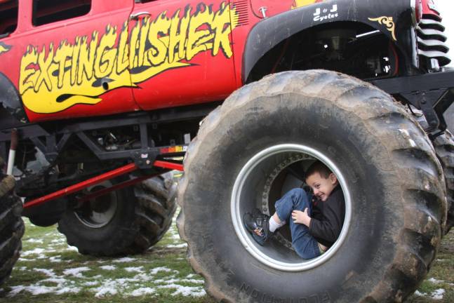Monster truck event collect toys for local children Nicholas Roberts of Oakridge enjoyed the monster truck ride and checking out the big wheels when the ride was done.