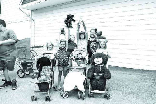 Zoey, Shane, Davin, Abby, Kaitlyn, Stephanie and Kendra of Ogdensburg came with bears of all sizes to Space Farms Teddy Bear Day on Saturday.