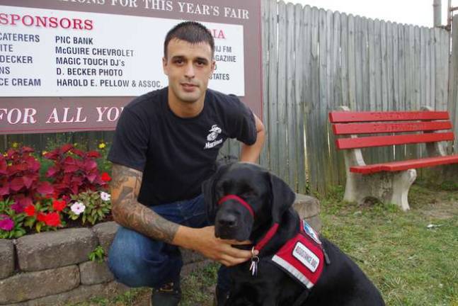 Ogdensburg resident Corey Houghtaling and his Labrador Retriever Atticus toured the fair on Saturday. Following two tours of duty in Afghanistan as a marine, Houghtaling uses the dog to ease his post-traumatic stress disorder.