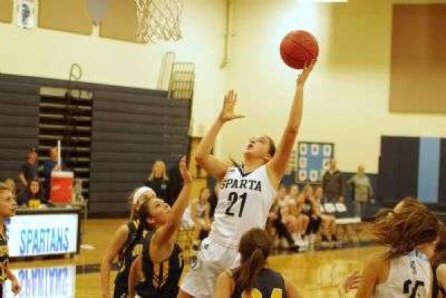 Sparta's Emily Dilger jumps up high toward the hoop during a shot. Dilger scored 12 points.