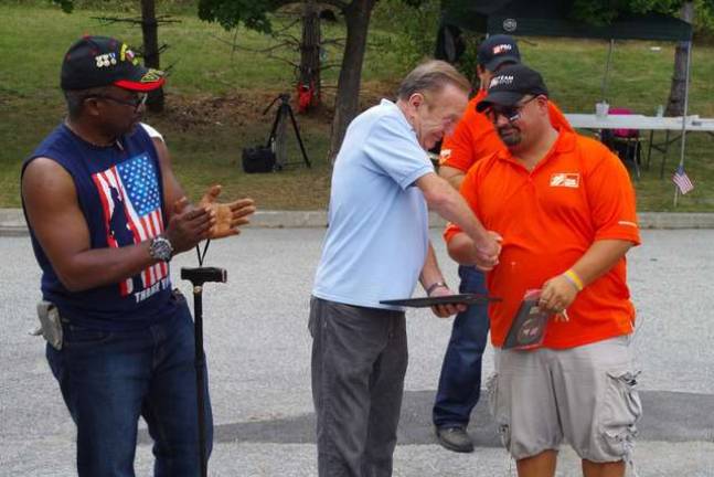 As Hamburg veteran George Alapka looks on Elk Fred Spages presents a certificate to team leader and Wantage resident Joseph Coscia, the Dover Home Depot store manager.