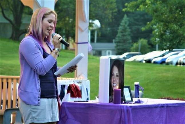 Vigil organizer Angela Lamendola speaks to those gathered at a candlelight vigil for Christine Solaro, 37, who was allegedly fatally shot by estranged husband Acting Newark Police Lt. John Formisano July 14.