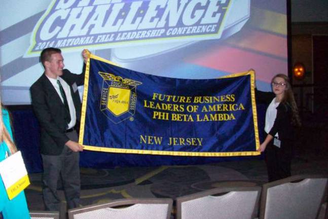 Wallkill Valley FBLA members Scott Mueller and Cagney Conner hold the New Jersey FBLA banner to rally New Jersey members at the 2014 National Fall Conference.