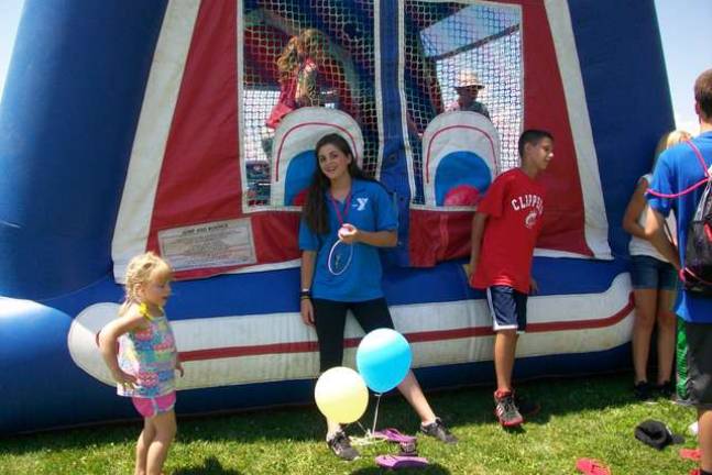 FBLA President Carly DeOliveira keeps an eye on the participants in the Bounce House at the SEFC Breakaway Camp Carnival.
