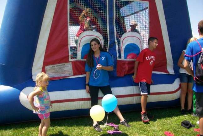 Wallkill Valley HS FBLA members complete project FBLA President Carly DeOliveira keeps an eye on the participants in the Bounce House at the SEFC Breakaway Camp Carnival.