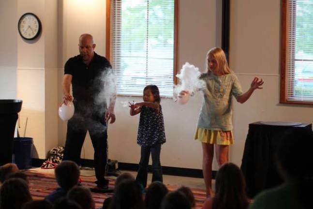 Jeff Boyer with volunteers Mia and Caitlin of Vernon with smoke and bubbles