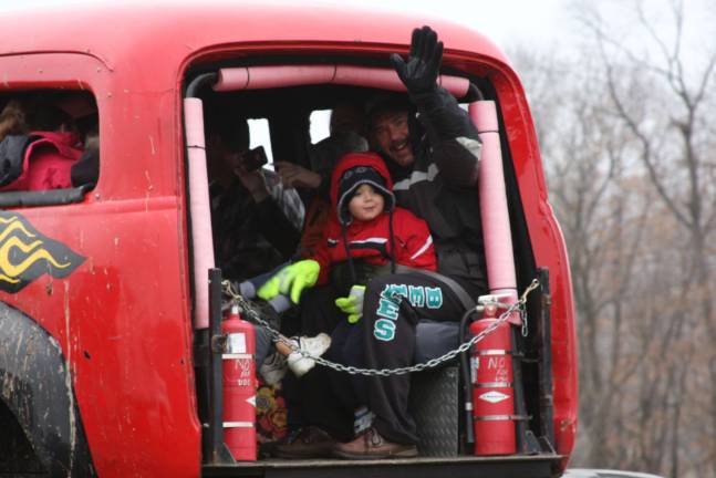 Monster truck event collect toys for local children Donald Sr. and David Keimer of Hamburg get a ride on the monster truck at the Chatterbox toy drive.
