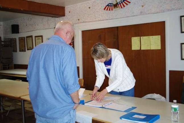 Photo by Chris Wyman Franklin resident Jane Massey is shown assisting a voter at Franklin&#x2019;s American Legion Post, which served Franklin&#x2019;s District 3.