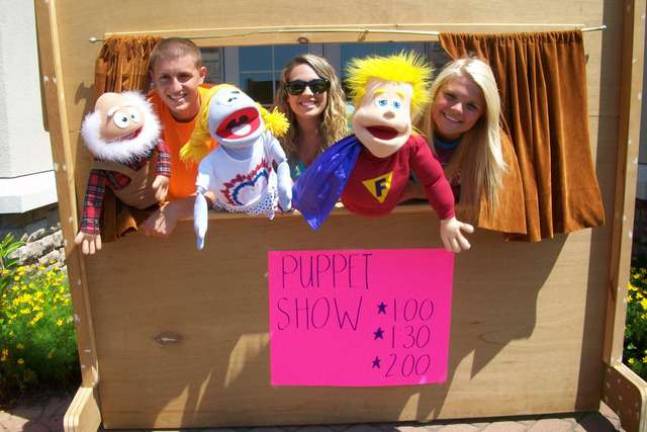 FBLA members Vinny Moncelsi, Melanie Kardos, and Paige Dunlap prepare for the puppet show at the SEFC Breakaway Carnival.