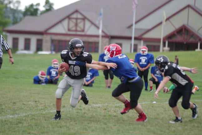 Area youth football teams participate in Ranger Rumble Seventh-grade Wallkilll Valley quarterback Alex Mastroianni in the grasp of a Lenape Valley Patriot.