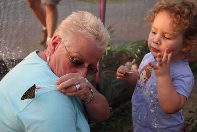 Edie Seabey and Emily of Franklin have a close encounter with a butterfly.
