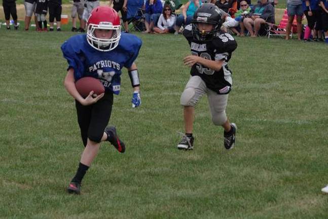 Area youth football teams participate in Ranger Rumble Lenape Valley QB Trey Stasse on the run from a Wallkill Valley defender in the sixth-grade scrimmage.