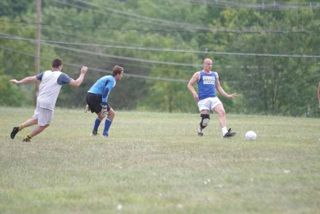 Far right Vernon Township High School graduate Travis Eustace about to kick the ball.