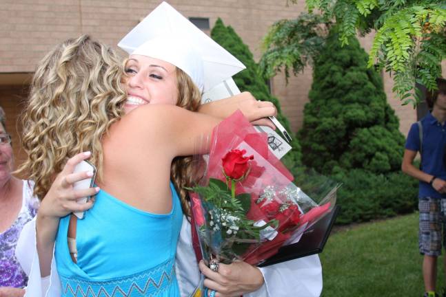 Time to celebrate Graduate Kristina Garrera gets a big hug.