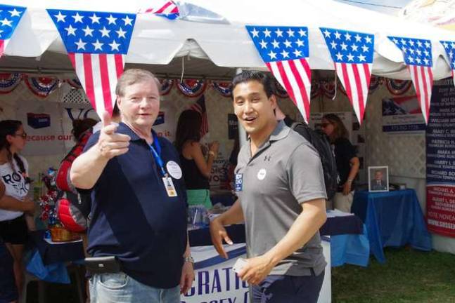 Phil King of Vernon notices the camera as he chats with Fifth Congressional District candidate Roy Cho.