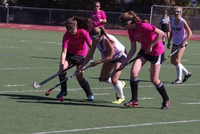 In the middle High Point's Melissa Way reaches out with her stick for the ball. Delaware Valley High School defeated High Point Regional High School in varsity field hockey. The final score was 1-0. The game took place at Delaware Valley High School in Milford, Pennsylvania.