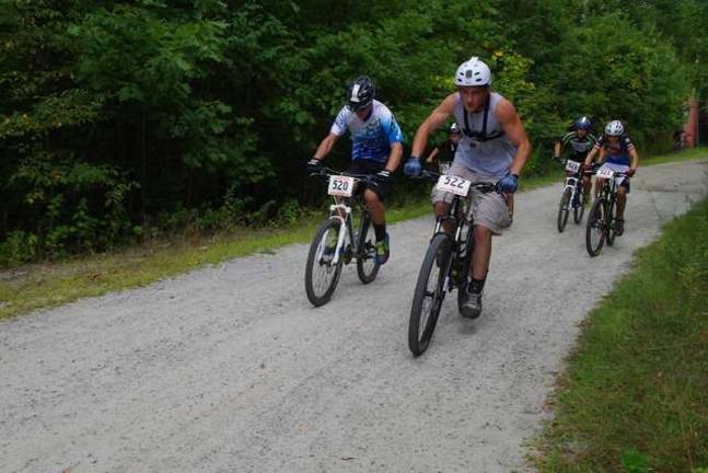 More than 100 mountain bikers race at Mountain Creek Racers in the in the Category 3 Junior Men's Division in the 15-18 age group are shown at the start of the racecourse.