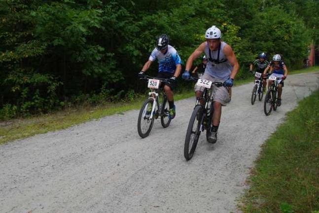 Racers in the in the Category 3 Junior Men's Division in the 15-18 age group are shown at the start of the racecourse.