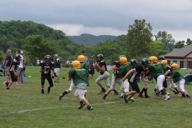 Area youth football teams participate in Ranger Rumble Seventh-grade Wallkilll Valley quarterback Alex Mastroianni looks to throw against the Long Valley Raiders.