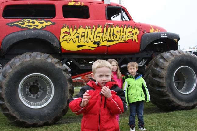 Monster truck event collect toys for local children Travis, Makayla and Michael of Hamburg and Franklin just had their turns on the monster truck ride through the fields.