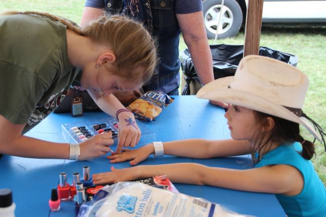 This cowgirl is getting her nails ready for the rodeo.