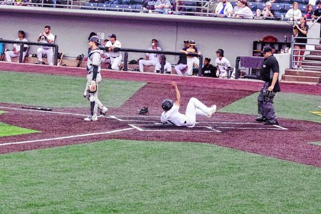 Miners leading division <b>In the fifth inning of the Sussex County Miners’ game against the Québec Capitales on June 13, Dom Johnson of the Miners slides safe across home plate to increase his team’s lead to 3-0. The Miners won, 6-0. (Photos by George Leroy Hunter)</b>